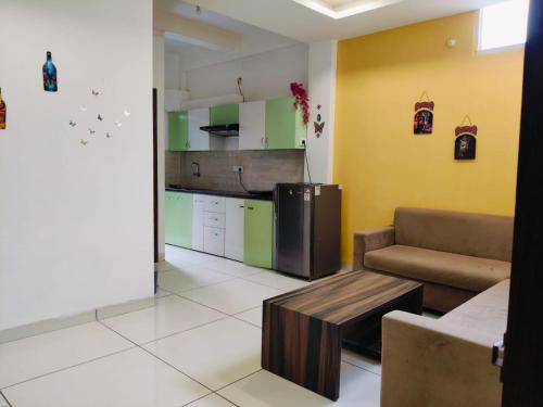 a kitchen with a couch and a table in a room at Fully Private 1BHK Couple Friendly at Serene Green Entire rental unit in Indore, India in Indore