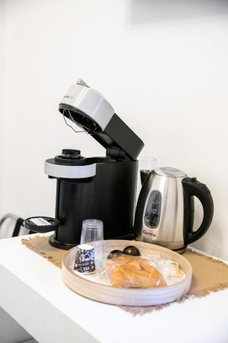 a coffee maker and a plate of food on a counter at Carlo's House in Bosa