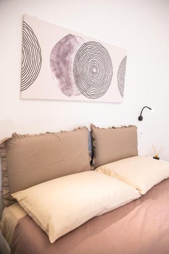 a bed with two pillows in a room at Carlo's House in Bosa