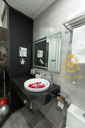 a bathroom with a sink with a red substance on it at Royal Hotel Kangnam in Hanoi
