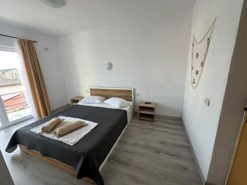 a bedroom with a bed and a clock on the wall at Vila Cornelius in Costinesti