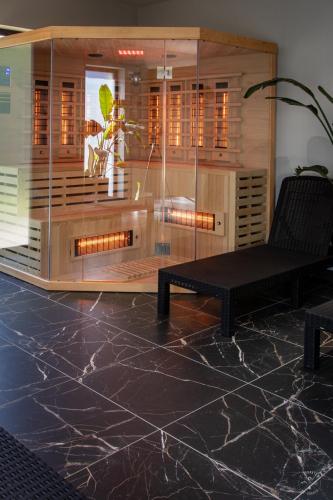 a glass room with a bench and a table at Sun View in Szklarska Poręba