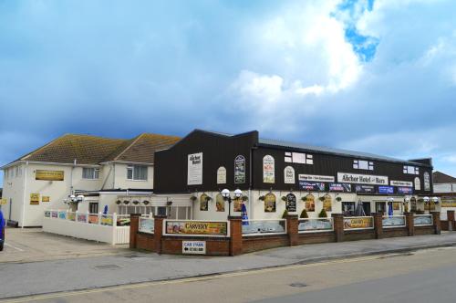 a building with signs on it on a street at The Anchor Hotel & Bars in Ingoldmells