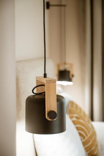 aendant light with a wooden block on top of it at Zante Sun Resort in Lithakia