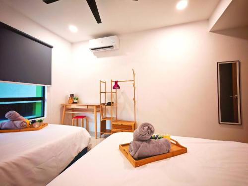 a bedroom with two beds with towels on them at Ipoh Manhattan Free Waterpark 3BR 8Pax Family Suite MHA308 by City Home Empire in Ipoh