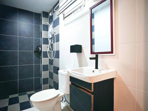 a bathroom with a sink and a toilet and a mirror at Ipoh Manhattan Free Waterpark 3BR 8Pax Family Suite MHA306 by City Home Empire in Ipoh