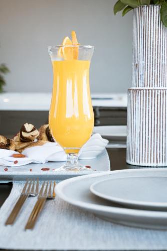 a glass of orange juice sitting on a table at Zante Sun Resort in Lithakia