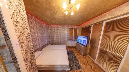 a room with a bed and a tv in it at Simona Guest House in Ruse