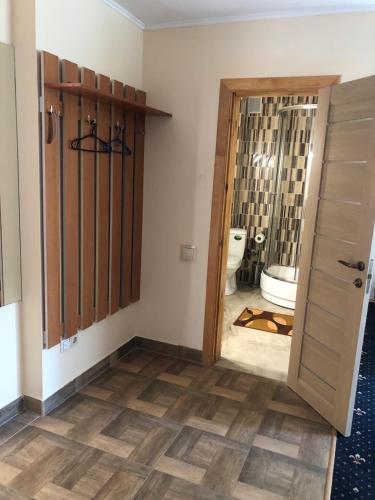 a bathroom with a toilet and a door leading to a bathroom with a toilet istg at Номер з кондиціонером in Chernihiv