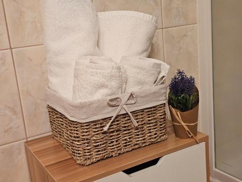 a basket with towels on a shelf in a bathroom at Family Apartments Suzi in Rovinj