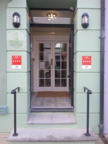a front door of a building with a sign that reads just house at The Southcliff in Tenby