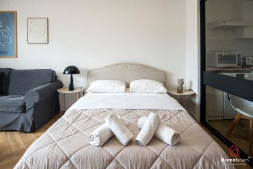 a bedroom with a bed with towels on it at Kleoniki's Boutique apartment By Homebrain in Alexandroupoli