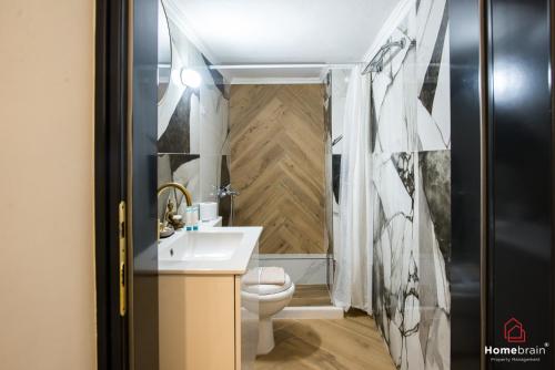 a bathroom with a toilet and a sink at Kleoniki's Boutique apartment By Homebrain in Alexandroupoli