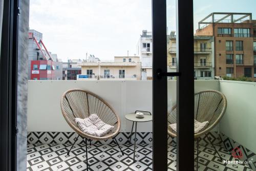 a balcony with two chairs and a table at Kleoniki's Boutique apartment By Homebrain in Alexandroupoli