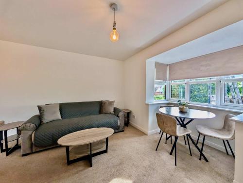a living room with a couch and a table at Charming and Modern 1-Bedroom Flat in Slough