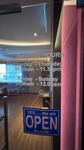 a open sign hanging on a door in a room at Ukiyo Hotel by manatidur in Petaling Jaya