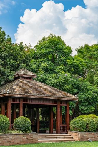 a pavilion in a park with trees in the background at InterContinental Kunming by IHG in Kunming