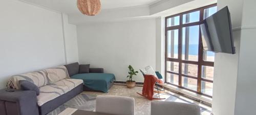 a living room with a couch and a flat screen tv at Buarcos&Sea Accommodation - Cristal Mar - Your Panoramic Ocean View Retreat in Figueira da Foz