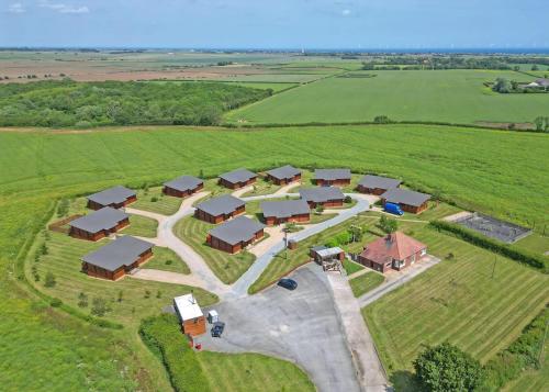 an aerial view of a farm with a group of buildings at Fairview Lodges in Hollym