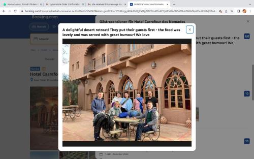 a screenshot of a website with a picture of a group of people at Hotel Carrefour des Nomades in Mhamid