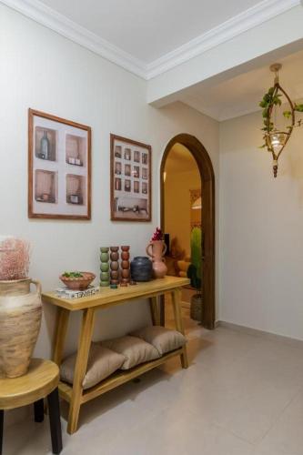a living room with a table and a chair at Fancy Pyramids View Khan Giza's Gem in Cairo