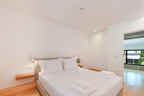 Katil atau katil-katil dalam bilik di Casas D' Além by Sé Apartamentos