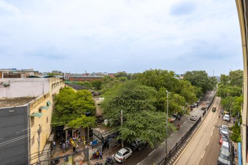 a view of a city street with trees and cars at The SM Hotel By RMR Hotels in New Delhi