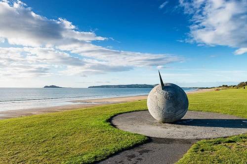 a large rock sitting on the side of a beach at Bright Spacious Apartment in Dublin