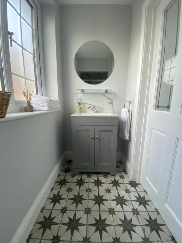 a bathroom with a sink and a mirror at Westover in Reigate