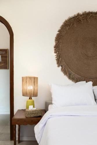 a bedroom with a bed and a table with a lamp at Fancy Pyramids View Khan Giza's Gem in Cairo