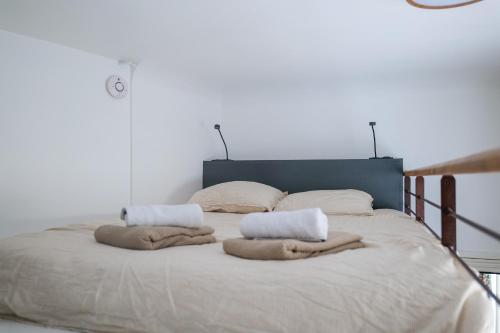 a bedroom with a large bed with towels on it at Appartement charme de l'ancien Angers - 2 personnes in Angers