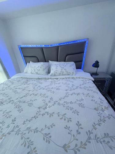 a bedroom with a bed with a blue headboard at CN Tower & Lake views, 1 bedroom plus den in Toronto