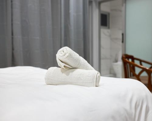 a towel sitting on top of a bed at Cycad Beach Resort- Chalets in Praia de Macaneta