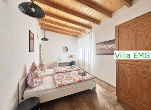 a bedroom with a bed and a wooden ceiling at Haus EMG Hockenheim in Hockenheim