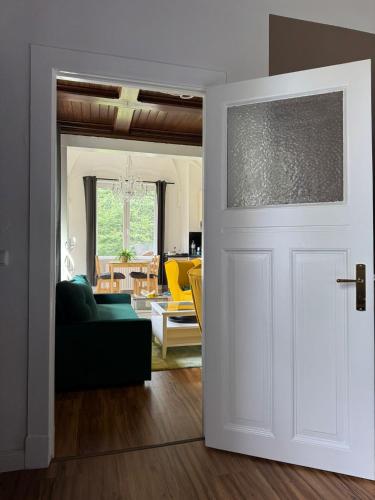 a white door leading into a living room with a couch at Hoopter's Quartier in Winsen Luhe