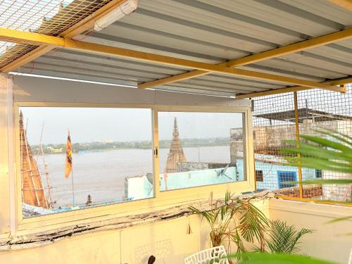 a large window with a view of the water at Holy River Stays in Varanasi