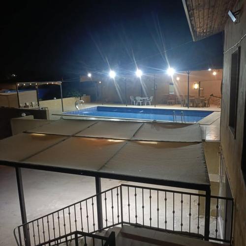 a swimming pool at night with at Chalet Adam- Ajloun شاليه ادم in Ajloun
