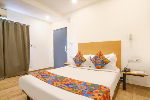 a bedroom with two beds in a room at FabHotel Cinco in Hyderabad