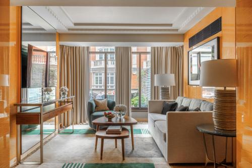a living room with a couch and a table at Four Seasons Hotel London at Park Lane in London