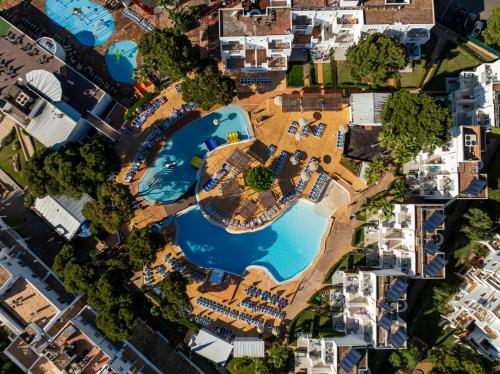 an aerial view of a pool in a city at Hotel Club Es Talaial in Cala d´Or