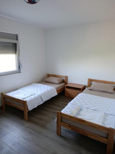 a room with two beds and a window at Andjela LUX in Belgrade