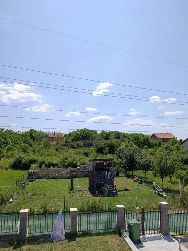 a truck in a field behind a fence at Andjela LUX in Belgrade