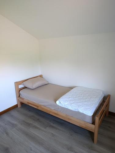 a bed with a wooden frame in a room at Andjela LUX in Belgrade