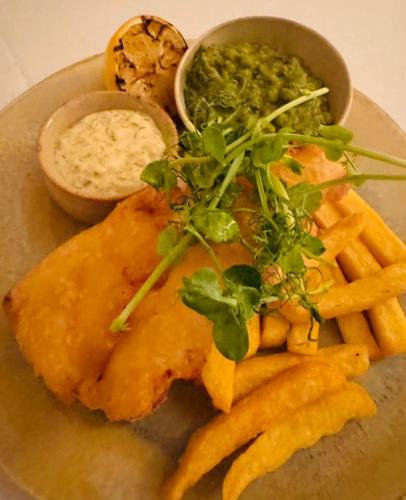 a plate of food with fish and fries and dip at Thomas Arms Hotel in Llanelli