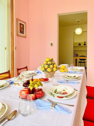 a table with plates of food and fruit on it at Villa Celeste Argegno - Lake Como in Argegno