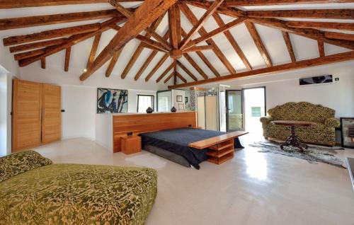 a bedroom with a bed and a table in a room at Villa Jardin by Villas Guide in Tkon