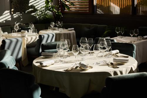 a row of tables with wine glasses and napkins at Four Seasons Hotel London at Park Lane in London