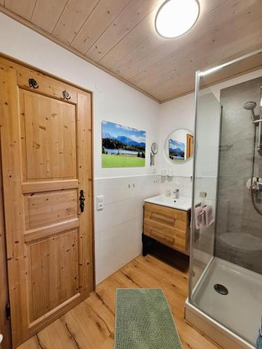 a bathroom with a shower and a sink at Ferienhaus Böck - Haus Karg in Seeg