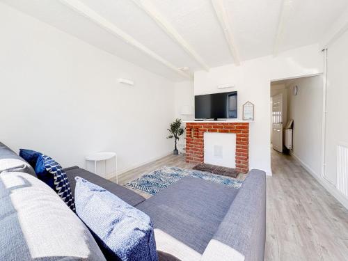 a living room with a couch and a fireplace at York Road in Great Yarmouth
