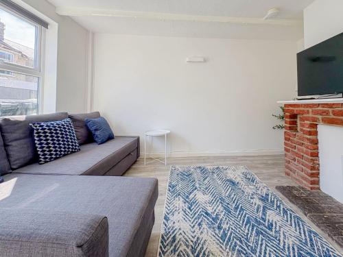 a living room with a couch and a fireplace at York Road in Great Yarmouth
